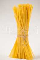 Bundle of raw spaghetti tied with rope