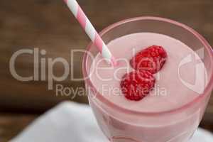 Fresh glass of smoothie with straw