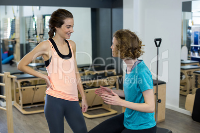 Female trainer interacting with woman