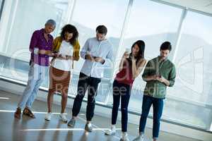 Creative business team using mobile phone in office