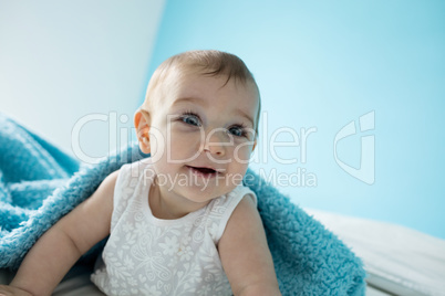 Cute baby girl smiling on bed