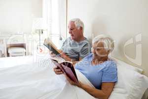 Senior couple reading books in the bedroom