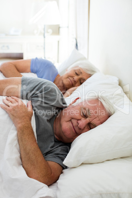 Senior couple sleeping in the bedroom