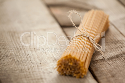 Bundle of raw spaghetti tied with rope