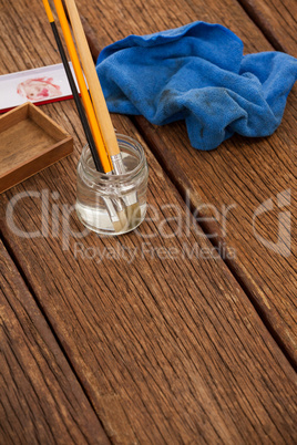 Paint brush in a jar filled with water and cloth