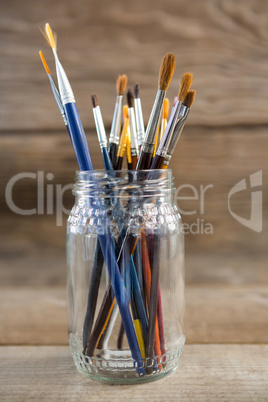 Various paintbrush in a glass jar