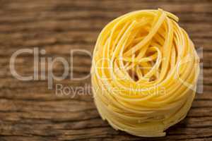 Tagliatelle pasta on wooden surface