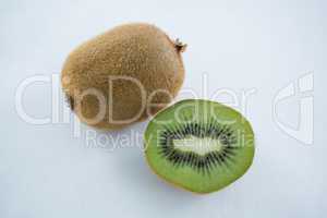 Halved kiwi on white background