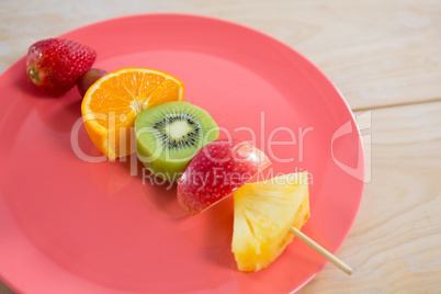 Close-up of fruit skewers in plate