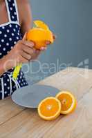 Woman peeling orange