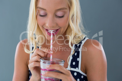 Beautiful woman drinking smoothie