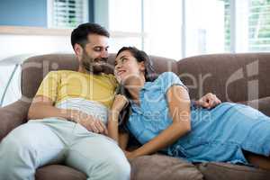 Smiling couple relaxing in the living room