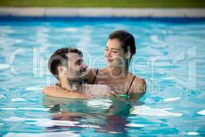 Young couple embracing each other in the pool