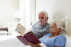 Senior couple reading books in the bedroom