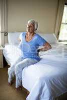Senior woman suffering from backache in the bedroom