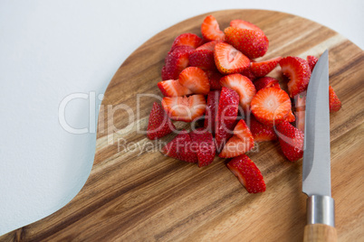 Slices of strawberries on chopping board