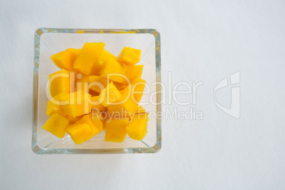 Chopped mangoes in glass bowl