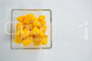 Chopped mangoes in glass bowl