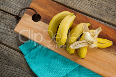 Overhead of fresh bananas on chopping board