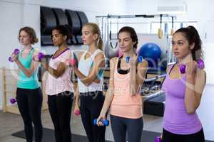 Group of women exercising with dumbbells