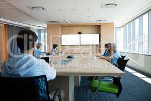 Creative business team attending a video call in conference room