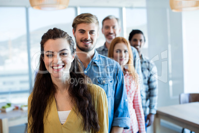 Happy creative business team standing in a line