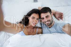 Portrait of romantic couple sleeping on bed