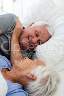 Senior couple relaxing in the bedroom