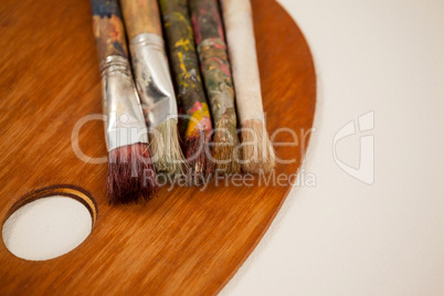 Wooden palette and paint brushes