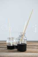 Paintbrushes with black paint dipped into water