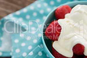 Close-up of fresh strawberries with cream in bowl