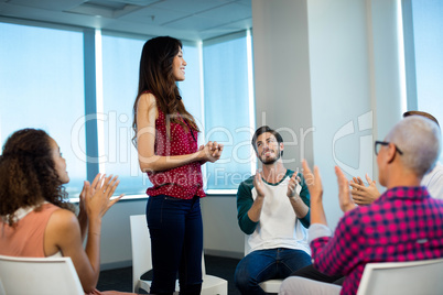 Creative business team applauding their colleague