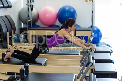 Woman exercising on reformer