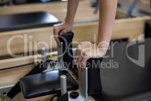 Woman practicing pilates in fitness studio