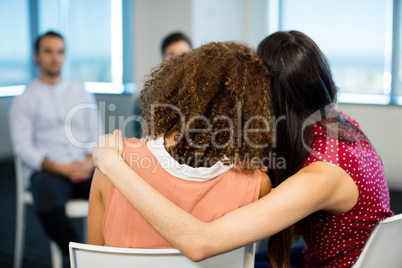 Creative businesswoman embracing each other at office