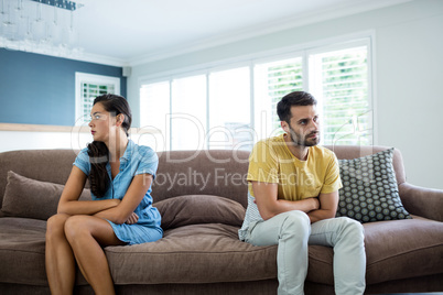 Couple ignoring each other in the living room
