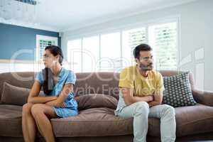 Couple ignoring each other in the living room