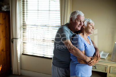 Senior couple embracing each other in the bedroom