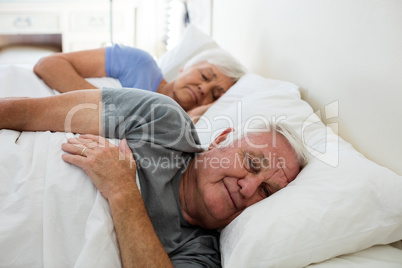 Senior couple sleeping in the bedroom