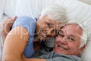 Senior couple embracing each other in the bedroom