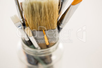 Close-up of various paintbrush in a jar