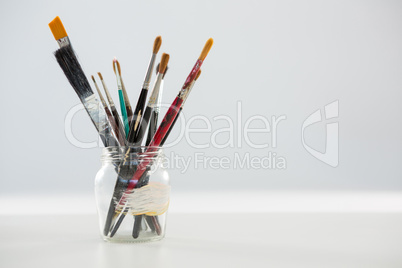 Various paintbrush in a jar