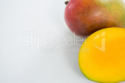 Halved mango on white background