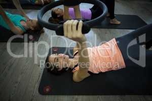 Fit women exercising with pilates ring