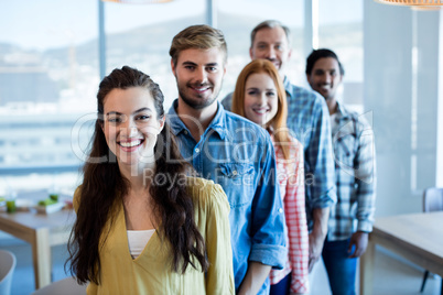 Happy creative business team standing in a line