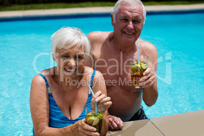 Portrait of senior couple holding glasses of iced tea