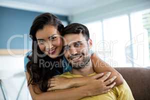 Portrait of smiling couple embracing each other in the living room