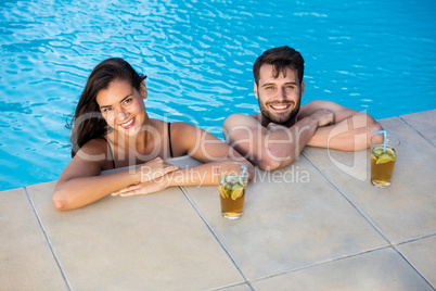 Portrait of young couple relaxing in the pool