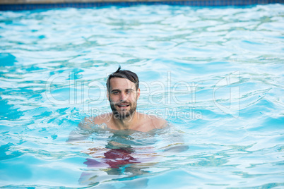 Portrait of young man relaxing in the pool