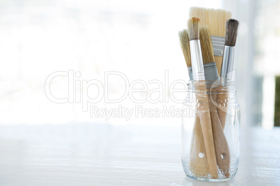 Various paintbrush in glass jar